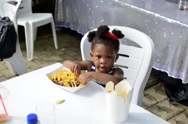 Little Miss Aluko enjoying a meal of cchicken and Chips from Grind Grill Cafe