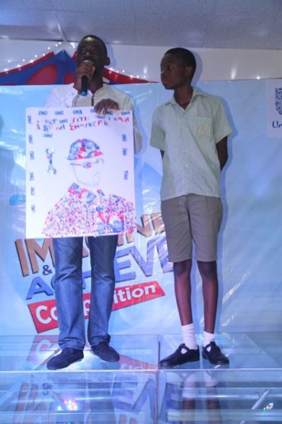 Assistant Category Manager Fab Cleaning, Unilever Nigeria, Adetayo Adesokan and winner of 200 thousand naira, from De Brain Foundation School, Kaduna, Sunday Daniel at the Omo Imagine and Achieve Competition grand finale in Lagos