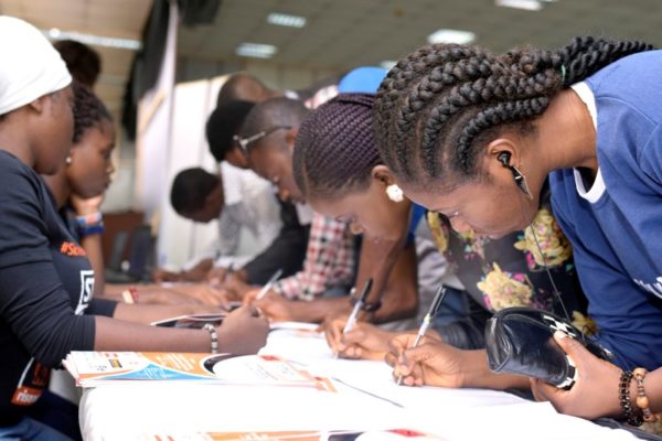 Participants registering by the registration stand at the #IYD2016NG event